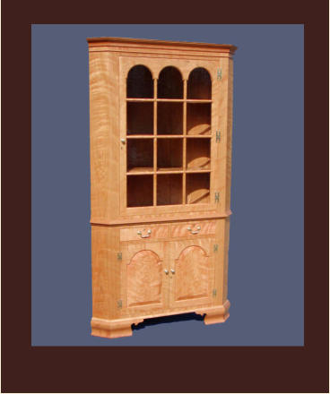 reproduction of a virginia corner cabinet in cherry with tombstone doors and antique glass